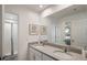 Bright bathroom featuring double sinks, a large mirror, and an adjacent shower room at 8951 Hilton Ridge Ave, Kissimmee, FL 34747