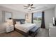 Comfortable bedroom with a large window, tray ceiling, and stylish decor at 8951 Hilton Ridge Ave, Kissimmee, FL 34747