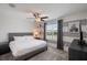 A spacious bedroom with stylish gray and white decor, including a queen bed and a ceiling fan at 8951 Hilton Ridge Ave, Kissimmee, FL 34747