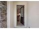Inviting entryway with tiled floors, decorative stone wall, and a view into the home at 8951 Hilton Ridge Ave, Kissimmee, FL 34747