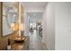 Hallway with tiled floor, decorative table, mirror and views of other rooms at 8951 Hilton Ridge Ave, Kissimmee, FL 34747