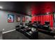 A home theater room with comfortable seating, a projector, and a tiered floor at 8951 Hilton Ridge Ave, Kissimmee, FL 34747