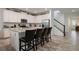 Modern kitchen featuring white cabinetry, stainless steel appliances, and an island with barstool seating at 8951 Hilton Ridge Ave, Kissimmee, FL 34747