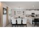 Bright eat-in kitchen featuring modern lighting, white cabinets, stainless appliances, and large table at 8951 Hilton Ridge Ave, Kissimmee, FL 34747