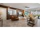Spacious living room featuring wood accent wall, tile floor, and sliding doors to lanai at 8951 Hilton Ridge Ave, Kissimmee, FL 34747