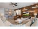 Stylish living room featuring a wood-paneled accent wall, plush seating, and an open layout at 8951 Hilton Ridge Ave, Kissimmee, FL 34747