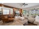 A beautifully decorated living room with wood-paneled accent wall and sliding glass doors to the outdoor space at 8951 Hilton Ridge Ave, Kissimmee, FL 34747