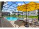 Relaxing pool area with an umbrella and lounge chairs, perfect for enjoying sunny days and outdoor recreation at 8951 Hilton Ridge Ave, Kissimmee, FL 34747