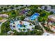 A high angle shot featuring the community water park, with slides, pools, and lounge areas at 8951 Hilton Ridge Ave, Kissimmee, FL 34747