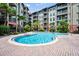 Beautiful community pool surrounded by lush landscaping and multi-story condo buildings at 911 N Orange Ave # 443, Orlando, FL 32801