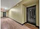 Clean hallway leading to unit with wood flooring and neutral paint at 911 N Orange Ave # 443, Orlando, FL 32801