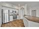 Bright kitchenette features white cabinets, stainless steel appliances, and granite countertops at 911 N Orange Ave # 443, Orlando, FL 32801