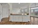Kitchenette area featuring stainless steel appliances, breakfast bar, and a view to the patio at 911 N Orange Ave # 443, Orlando, FL 32801