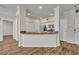 Kitchenette showing breakfast bar, white cabinetry and stainless steel appliances at 911 N Orange Ave # 443, Orlando, FL 32801