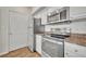 Kitchenette with stainless steel appliances, plenty of storage, and neutral countertops at 911 N Orange Ave # 443, Orlando, FL 32801