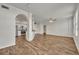 Open-concept living room featuring wood floors and an adjacent kitchen with stainless steel appliances at 911 N Orange Ave # 443, Orlando, FL 32801