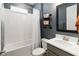 Bathroom features a white tiled shower/tub combo, modern vanity, framed mirror, and contemporary finishes at 971 Braewood Dr, Clermont, FL 34715