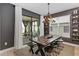 Contemporary dining room features a wooden table, stylish seating, modern lighting and sliding glass doors to screened porch at 971 Braewood Dr, Clermont, FL 34715
