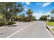 Community entrance with guard house, lush tropical landscaping and palm trees at 971 Braewood Dr, Clermont, FL 34715