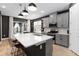 Modern kitchen with island, stainless appliances, wood look tile floors, and dark gray walls at 971 Braewood Dr, Clermont, FL 34715