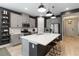 Modern kitchen with stainless steel appliances, gray cabinets, a white countertop island, and wood look tile floors at 971 Braewood Dr, Clermont, FL 34715