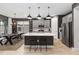 Open kitchen features modern appliances, gray cabinetry, a large island, and wood look tile floors at 971 Braewood Dr, Clermont, FL 34715