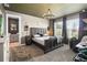 Spacious main bedroom suite boasts a decorative ceiling, natural light, carpet flooring, and an ensuite bathroom at 971 Braewood Dr, Clermont, FL 34715