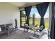 Relaxing screened porch featuring comfortable seating, outdoor decor, and views of the backyard at 971 Braewood Dr, Clermont, FL 34715