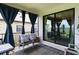 Relaxing screened porch boasts comfortable seating, stylish decor, and pleasant views at 971 Braewood Dr, Clermont, FL 34715