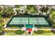 Aerial view of the tennis courts surrounded by lush landscaping and greenery at 971 Braewood Dr, Clermont, FL 34715