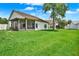 Expansive backyard with a screened lanai overlooking the well-manicured lawn at 11548 Pumpkin Seed Ct, Orlando, FL 32821