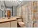 Bathroom with a neutral color scheme, a large mirror, and patterned shower curtain at 11548 Pumpkin Seed Ct, Orlando, FL 32821