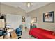 Bedroom boasts neutral carpet, a ceiling fan, an office area, and large closet at 11548 Pumpkin Seed Ct, Orlando, FL 32821