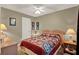 Inviting bedroom features a quilt bedspread, neutral carpet, and side tables at 11548 Pumpkin Seed Ct, Orlando, FL 32821
