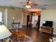 Open-concept dining room with wood floors, a chandelier, and seamless flow to the living area at 11548 Pumpkin Seed Ct, Orlando, FL 32821