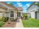 Inviting home entrance with landscaped walkway and blooming flowers, creating a welcoming first impression at 11548 Pumpkin Seed Ct, Orlando, FL 32821