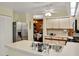 Bright kitchen features stainless steel appliances, laminate countertops and a ceiling fan at 11548 Pumpkin Seed Ct, Orlando, FL 32821