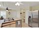 Open kitchen with stainless steel appliances, a breakfast bar, and tile flooring, providing a modern and functional space at 11548 Pumpkin Seed Ct, Orlando, FL 32821