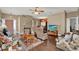 Spacious living room connected to the dining area, featuring hardwood floors and comfortable furnishings at 11548 Pumpkin Seed Ct, Orlando, FL 32821