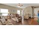 Cozy living room with hardwood floors, comfortable seating, and natural light creating a warm atmosphere at 11548 Pumpkin Seed Ct, Orlando, FL 32821