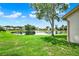 Backyard view with a large tree and a pond at 11548 Pumpkin Seed Ct, Orlando, FL 32821