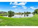 Scenic view of a calm pond reflecting the surrounding neighborhood at 11548 Pumpkin Seed Ct, Orlando, FL 32821