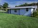 Exterior view of house featuring a covered patio, storage shed, and a spacious backyard at 1200 Ne 45Th Pl, Ocala, FL 34479