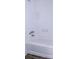 Clean bathroom featuring tiled walls, and a bright white tub at 1200 Ne 45Th Pl, Ocala, FL 34479