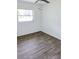A bright bedroom featuring modern wood-look flooring and a ceiling fan at 1200 Ne 45Th Pl, Ocala, FL 34479