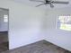 A bedroom featuring updated flooring, fresh paint, and a ceiling fan at 1200 Ne 45Th Pl, Ocala, FL 34479