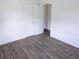 This bright bedroom features a closet with wood-look flooring at 1200 Ne 45Th Pl, Ocala, FL 34479