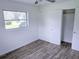 A bright bedroom featuring updated flooring, closet, and window views at 1200 Ne 45Th Pl, Ocala, FL 34479