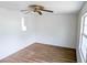 Cozy bedroom with a ceiling fan, large windows, and wood-look flooring at 1200 Ne 45Th Pl, Ocala, FL 34479