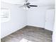 Comfortable bedroom boasts a ceiling fan, window, and stylish wood-look flooring at 1200 Ne 45Th Pl, Ocala, FL 34479